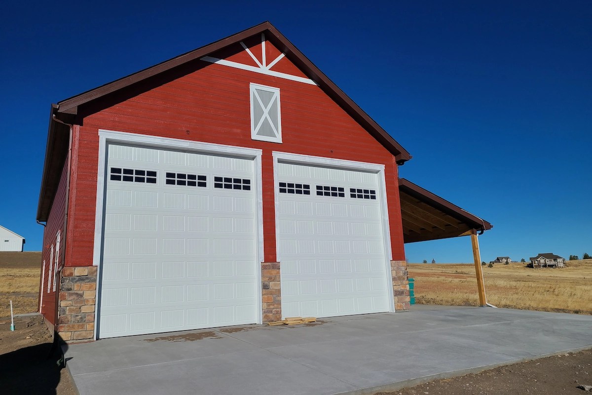 Detached garage with two overhead doors and covered lean-to in Colorado Springs area