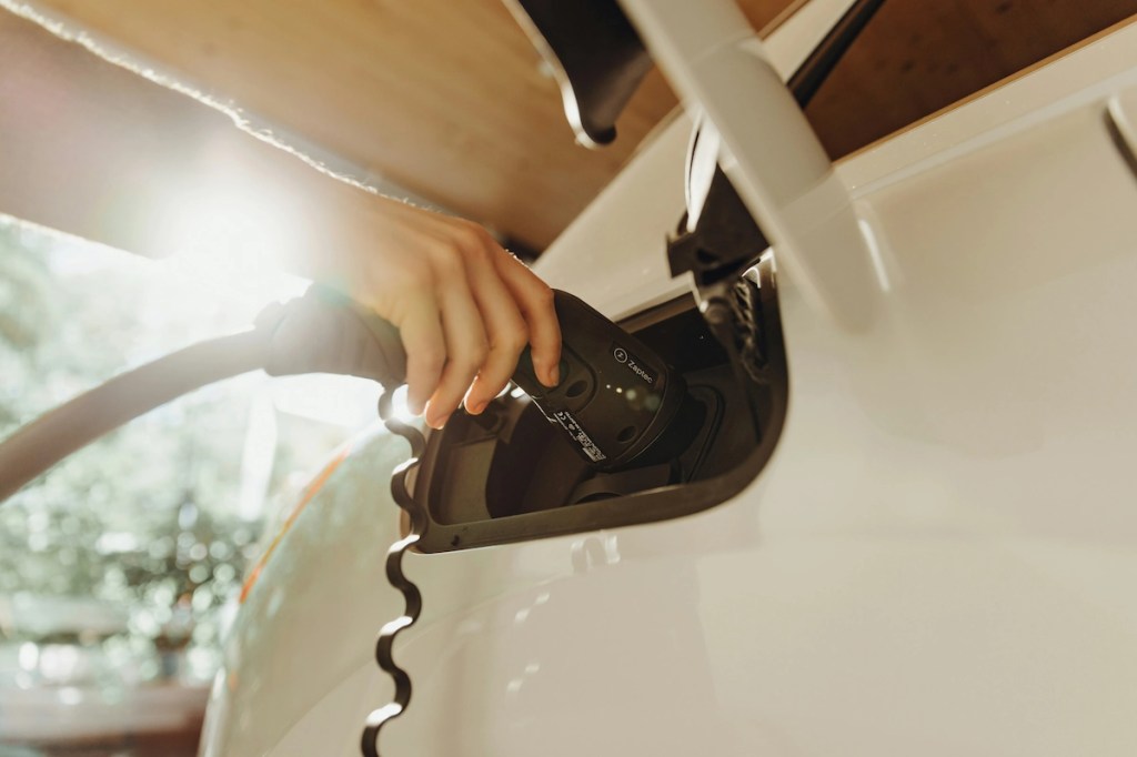 Electric vehicle plugged into a home charging station