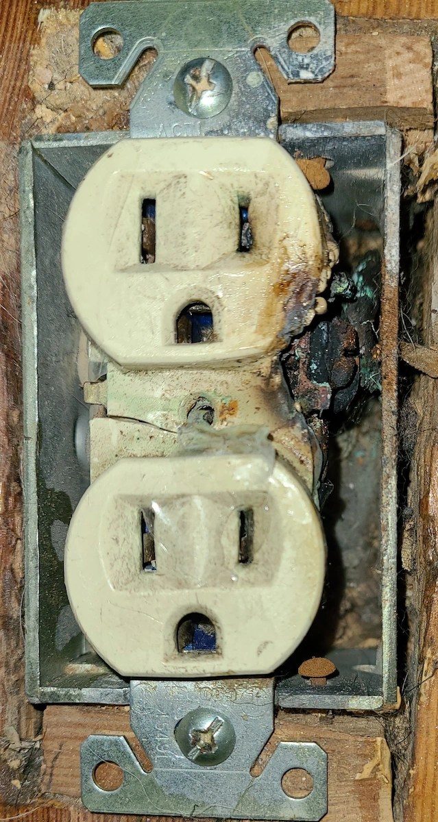 Burned and melted electrical outlet with heat damage found in a Colorado Springs home