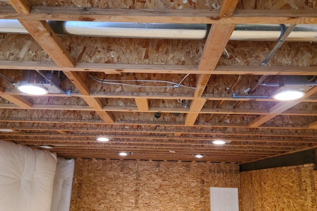 Recessed can lights installed in an unfinished basement ceiling by Bourland Electric LLC in Colorado Springs